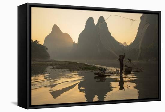 Cormorant Fisherman Throwing Net on Li River at Dawn, Xingping, Yangshuo, Guangxi, China-Ian Trower-Framed Stretched Canvas