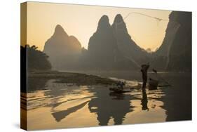 Cormorant Fisherman Throwing Net on Li River at Dawn, Xingping, Yangshuo, Guangxi, China-Ian Trower-Stretched Canvas