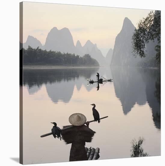 Cormorant fishermen in Li River-Martin Puddy-Stretched Canvas