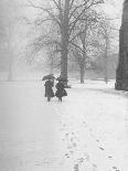 Snow Falling While People Take a Stroll Across Campus of Winchester College-Cornell Capa-Photographic Print