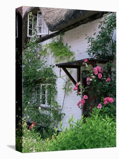 Cottage and Flowers, Wherwell, Hampshire, England, United Kingdom-Jean Brooks-Stretched Canvas