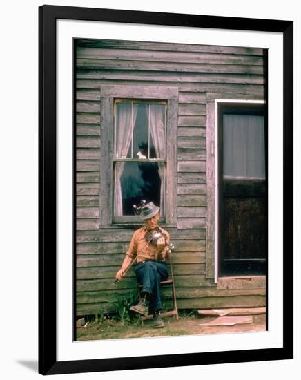 Country Musician, Fred Price, Sitting Outdoors in Front of Old House Playing the Fiddle-Michael Mauney-Framed Photographic Print