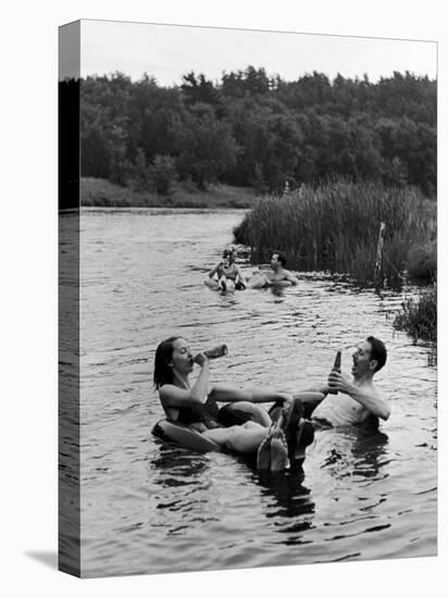 Couple Drinking Beer at Inner Tube Floating Party on the Apple River-Alfred Eisenstaedt-Stretched Canvas