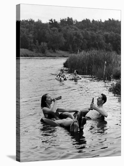 Couple Drinking Beer at Inner Tube Floating Party on the Apple River-Alfred Eisenstaedt-Stretched Canvas