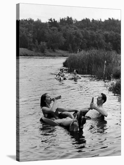 Couple Drinking Beer at Inner Tube Floating Party on the Apple River-Alfred Eisenstaedt-Stretched Canvas