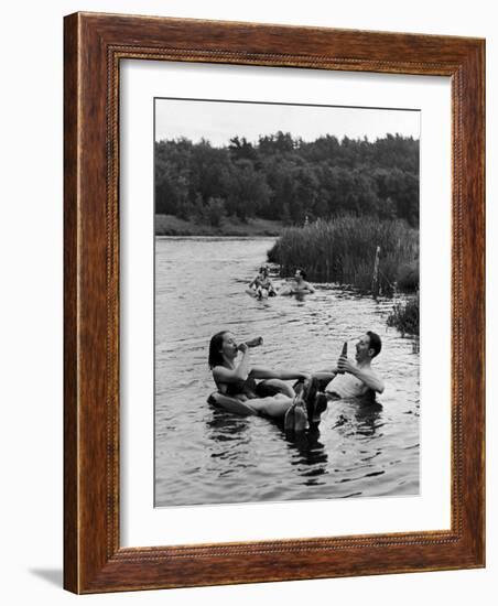 Couple Drinking Beer at Inner Tube Floating Party on the Apple River-Alfred Eisenstaedt-Framed Photographic Print