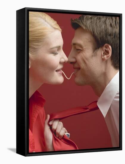 Couple Eating a Strand of Spaghetti from Both Ends-null-Framed Stretched Canvas