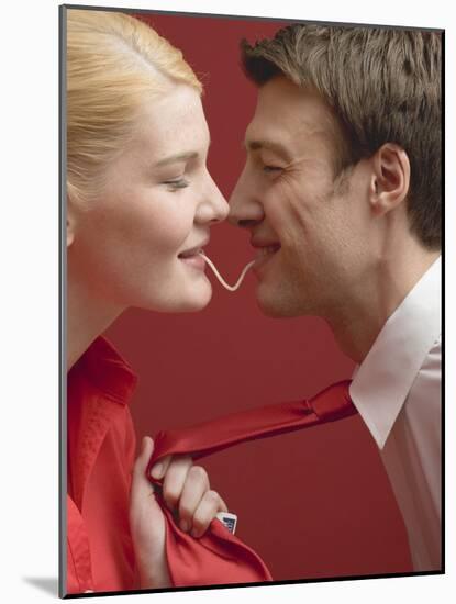 Couple Eating a Strand of Spaghetti from Both Ends-null-Mounted Photographic Print