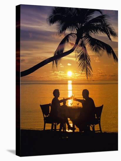 Couple Having Dinner at the Beach, Toasting Glasses, Maldives, Indian Ocean, Asia-Sakis Papadopoulos-Stretched Canvas