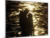 Couple Hug Each Other in the Winter Sunshine by the River Danube in Budapest, Hungary-null-Mounted Photographic Print