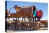 Couple of Tourists Visiting Cementerio De Trenes (Train Cemetery), Salar De Uyuni, Bolivia-Elzbieta Sekowska-Stretched Canvas