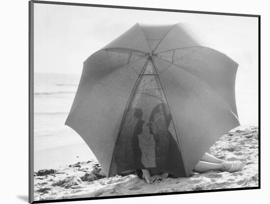 Couple on Beach under Umbrella-null-Mounted Photographic Print