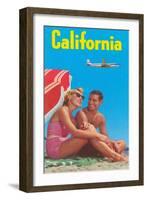 Couple on Beach with Airplane in Sky-null-Framed Art Print