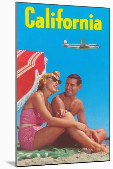 Couple on Beach with Airplane in Sky-null-Mounted Art Print