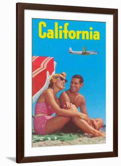 Couple on Beach with Airplane in Sky-null-Framed Art Print