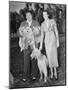 Couple Outside with Dog and Puppies-null-Mounted Photo