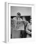 Couple Reading Newspaper Account of the Death of Evita Peron at 33 from Cancer-Alfred Eisenstaedt-Framed Photographic Print