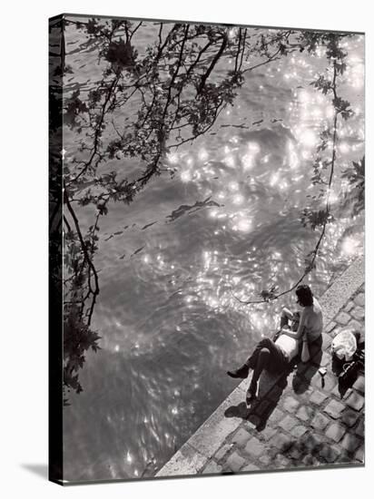 Couple Relaxing on Bank of Seine Near Notre Dame Cathedral During Lunch Hour-Alfred Eisenstaedt-Stretched Canvas