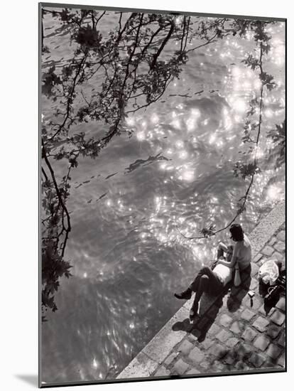 Couple Relaxing on Bank of Seine Near Notre Dame Cathedral During Lunch Hour-Alfred Eisenstaedt-Mounted Photographic Print