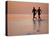 Couple Running on Beach, Felidu Atoll, Maldives-Stuart Westmorland-Stretched Canvas