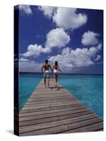 Couple Running on Dock, Curacao, Caribbean-Greg Johnston-Stretched Canvas