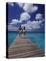 Couple Running on Dock, Curacao, Caribbean-Greg Johnston-Stretched Canvas