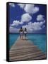 Couple Running on Dock, Curacao, Caribbean-Greg Johnston-Framed Stretched Canvas