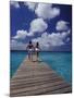 Couple Running on Dock, Curacao, Caribbean-Greg Johnston-Mounted Photographic Print