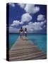 Couple Running on Dock, Curacao, Caribbean-Greg Johnston-Stretched Canvas