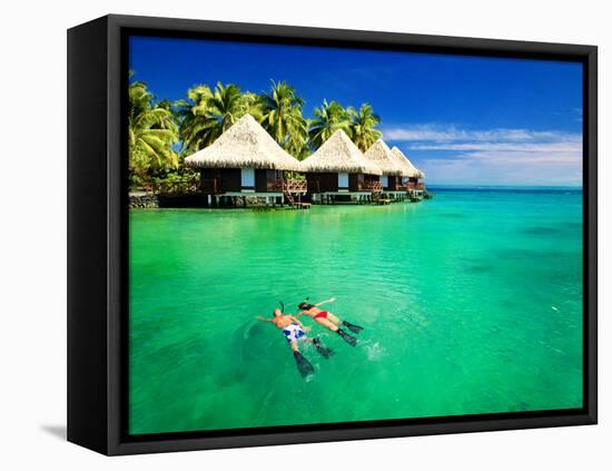 Couple Snorkling in Tropical Lagoon with over Water Bungalows-Martin Valigursky-Framed Stretched Canvas