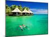 Couple Snorkling in Tropical Lagoon with over Water Bungalows-Martin Valigursky-Mounted Photographic Print