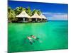 Couple Snorkling in Tropical Lagoon with over Water Bungalows-Martin Valigursky-Mounted Photographic Print