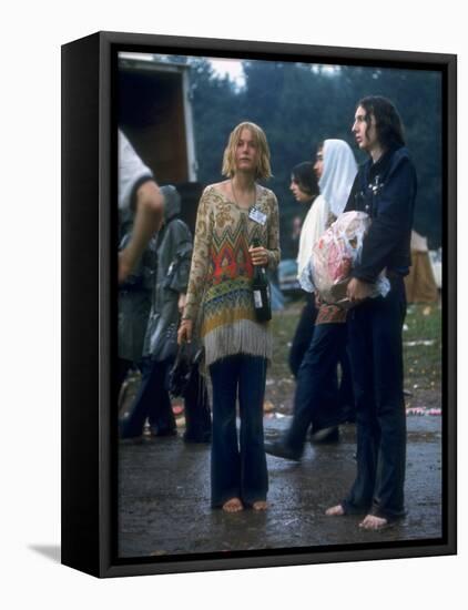 Couple Standing Barefoot on a Road Holding a Bundle and Wine Bottle, Woodstock Music and Art Fair-John Dominis-Framed Stretched Canvas