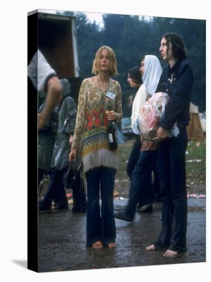 Couple Standing Barefoot on a Road Holding a Bundle and Wine Bottle, Woodstock Music and Art Fair-John Dominis-Stretched Canvas