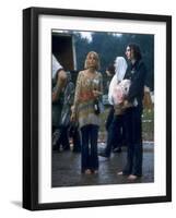 Couple Standing Barefoot on a Road Holding a Bundle and Wine Bottle, Woodstock Music and Art Fair-John Dominis-Framed Photographic Print