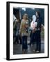 Couple Standing Barefoot on a Road Holding a Bundle and Wine Bottle, Woodstock Music and Art Fair-John Dominis-Framed Photographic Print