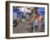 Couple Standing Outside Blue Painted Residential Haveli, Old City, Jodhpur, Rajasthan State, India-Eitan Simanor-Framed Photographic Print