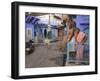 Couple Standing Outside Blue Painted Residential Haveli, Old City, Jodhpur, Rajasthan State, India-Eitan Simanor-Framed Photographic Print