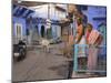 Couple Standing Outside Blue Painted Residential Haveli, Old City, Jodhpur, Rajasthan State, India-Eitan Simanor-Mounted Photographic Print