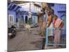 Couple Standing Outside Blue Painted Residential Haveli, Old City, Jodhpur, Rajasthan State, India-Eitan Simanor-Mounted Photographic Print