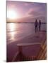 Couple Walking Along Beach at Sunset, Nassau, Bahamas, Caribbean-Greg Johnston-Mounted Photographic Print