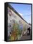 Couple Walking Along the East Side Gallery Berlin Wall Mural, Berlin, Germany, Europe-Simon Montgomery-Framed Stretched Canvas