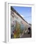 Couple Walking Along the East Side Gallery Berlin Wall Mural, Berlin, Germany, Europe-Simon Montgomery-Framed Photographic Print