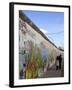 Couple Walking Along the East Side Gallery Berlin Wall Mural, Berlin, Germany, Europe-Simon Montgomery-Framed Photographic Print