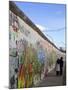 Couple Walking Along the East Side Gallery Berlin Wall Mural, Berlin, Germany, Europe-Simon Montgomery-Mounted Photographic Print