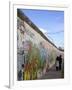 Couple Walking Along the East Side Gallery Berlin Wall Mural, Berlin, Germany, Europe-Simon Montgomery-Framed Photographic Print