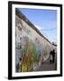 Couple Walking Along the East Side Gallery Berlin Wall Mural, Berlin, Germany, Europe-Simon Montgomery-Framed Photographic Print