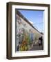 Couple Walking Along the East Side Gallery Berlin Wall Mural, Berlin, Germany, Europe-Simon Montgomery-Framed Photographic Print