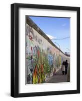 Couple Walking Along the East Side Gallery Berlin Wall Mural, Berlin, Germany, Europe-Simon Montgomery-Framed Photographic Print