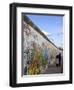 Couple Walking Along the East Side Gallery Berlin Wall Mural, Berlin, Germany, Europe-Simon Montgomery-Framed Photographic Print